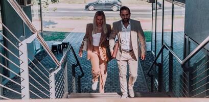 Modern business couple after a long day's work, walking together towards the comfort of their home, embodying the perfect blend of professional success and personal contentment. photo
