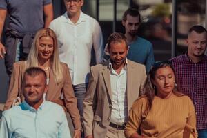 A diverse group of businessmen and colleagues walking together by their workplace, showcasing collaboration and teamwork in the company. photo