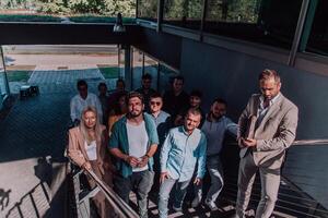 A diverse group of businessmen and colleagues walking together by their workplace, showcasing collaboration and teamwork in the company. photo