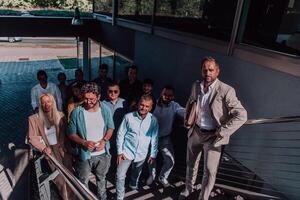 A diverse group of businessmen and colleagues walking together by their workplace, showcasing collaboration and teamwork in the company. photo