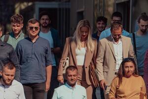 A diverse group of businessmen and colleagues walking together by their workplace, showcasing collaboration and teamwork in the company. photo