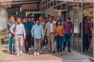 A diverse group of businessmen and colleagues walking together by their workplace, showcasing collaboration and teamwork in the company. photo