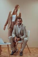 A business couple posing for a photograph together against a beige backdrop, capturing their professional partnership and creating a timeless image of unity and success. photo