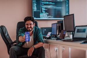 A programmer diligently testing smartphone applications while sitting in their office. photo