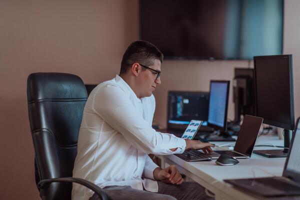 A programmer diligently testing smartphone applications while sitting in their office.