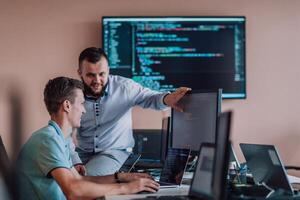 Programmers engrossed in deep collaboration, diligently working together to solve complex problems and develop innovative mobile applications with seamless functionality. photo