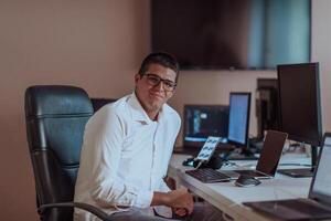 A programmer diligently testing smartphone applications while sitting in their office. photo