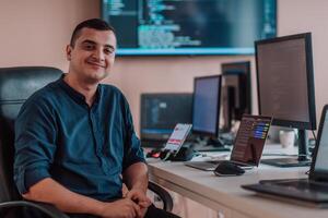 A programmer diligently testing smartphone applications while sitting in their office. photo