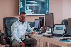 A programmer diligently testing smartphone applications while sitting in their office. photo