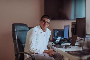 A programmer diligently testing smartphone applications while sitting in their office. photo