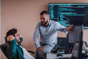 Programmers engrossed in deep collaboration, diligently working together to solve complex problems and develop innovative mobile applications with seamless functionality. photo