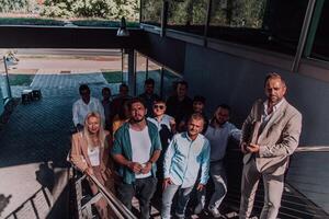 A diverse group of businessmen and colleagues walking together by their workplace, showcasing collaboration and teamwork in the company. photo