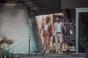 Modern business couple after a long day's work, walking together towards the comfort of their home, embodying the perfect blend of professional success and personal contentment. photo
