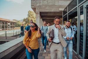 A diverse group of businessmen and colleagues walking together by their workplace, showcasing collaboration and teamwork in the company. photo