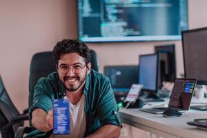 A programmer diligently testing smartphone applications while sitting in their office. photo