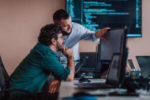 Programmers engrossed in deep collaboration, diligently working together to solve complex problems and develop innovative mobile applications with seamless functionality. photo