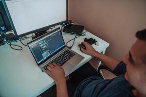 A programmer diligently testing smartphone applications while sitting in their office. photo