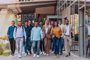 A diverse group of businessmen and colleagues walking together by their workplace, showcasing collaboration and teamwork in the company. photo