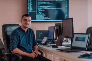 A programmer diligently testing smartphone applications while sitting in their office. photo