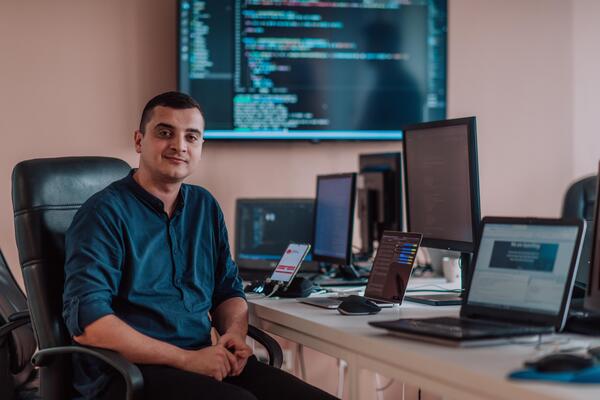 A programmer diligently testing smartphone applications while sitting in their office.