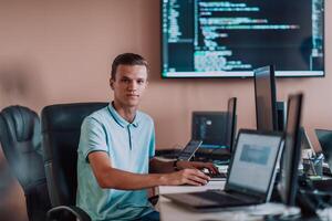 A programmer diligently testing smartphone applications while sitting in their office. photo