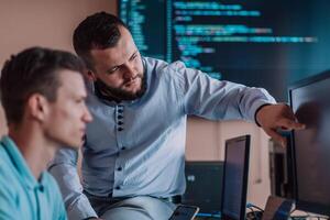 Programmers engrossed in deep collaboration, diligently working together to solve complex problems and develop innovative mobile applications with seamless functionality. photo