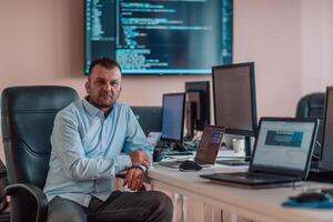 A programmer diligently testing smartphone applications while sitting in their office. photo
