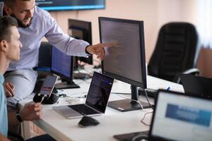 Programmers engrossed in deep collaboration, diligently working together to solve complex problems photo