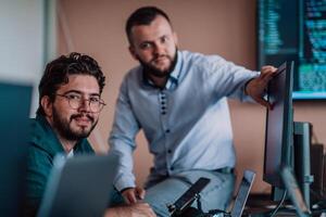 Programmers engrossed in deep collaboration, diligently working together to solve complex problems and develop innovative mobile applications with seamless functionality. photo