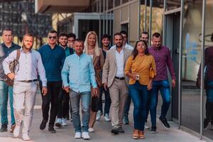 A diverse group of businessmen and colleagues walking together by their workplace, showcasing collaboration and teamwork in the company. photo
