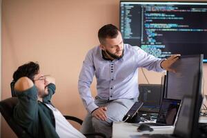 Programmers engrossed in deep collaboration, diligently working together to solve complex problems photo