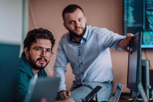 Programmers engrossed in deep collaboration, diligently working together to solve complex problems and develop innovative mobile applications with seamless functionality. photo