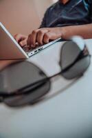 Close-up photo of a programmer typing on a laptop
