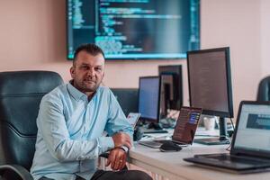 A programmer diligently testing smartphone applications while sitting in their office. photo