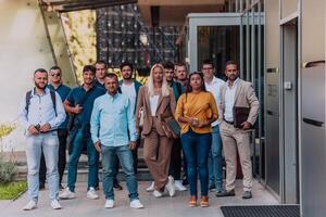 A diverse group of businessmen and colleagues walking together by their workplace, showcasing collaboration and teamwork in the company. photo
