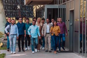 A diverse group of businessmen and colleagues walking together by their workplace, showcasing collaboration and teamwork in the company. photo