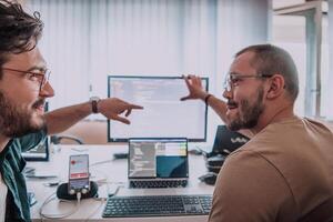 Programmers engrossed in deep collaboration, diligently working together to solve complex problems and develop innovative mobile applications with seamless functionality. photo