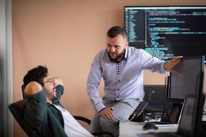 Programmers engrossed in deep collaboration, diligently working together to solve complex problems photo