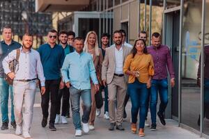 A diverse group of businessmen and colleagues walking together by their workplace, showcasing collaboration and teamwork in the company. photo