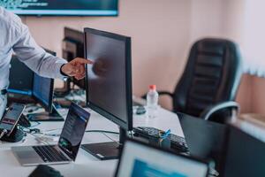 Programmers engrossed in deep collaboration, diligently working together to solve complex problems and develop innovative mobile applications with seamless functionality. photo