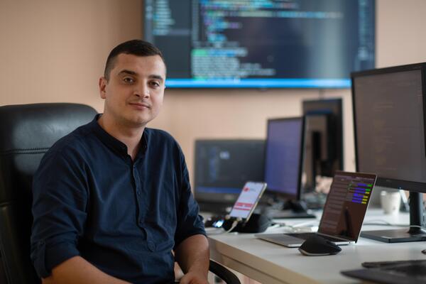 A programmer diligently testing smartphone applications while sitting in their office.