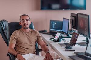 A programmer diligently testing smartphone applications while sitting in their office. photo