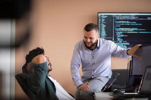 Programmers engrossed in deep collaboration, diligently working together to solve complex problems photo