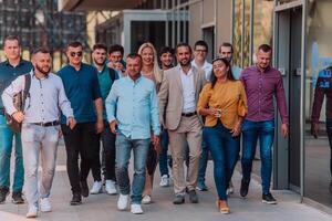 A diverse group of businessmen and colleagues walking together by their workplace, showcasing collaboration and teamwork in the company. photo