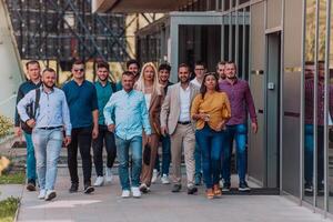 A diverse group of businessmen and colleagues walking together by their workplace, showcasing collaboration and teamwork in the company. photo