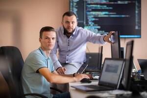 Programmers engrossed in deep collaboration, diligently working together to solve complex problems photo