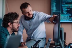 Programmers engrossed in deep collaboration, diligently working together to solve complex problems and develop innovative mobile applications with seamless functionality. photo