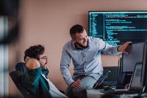 Programmers engrossed in deep collaboration, diligently working together to solve complex problems and develop innovative mobile applications with seamless functionality. photo