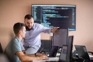 Programmers engrossed in deep collaboration, diligently working together to solve complex problems photo