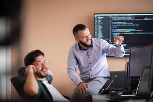 Programmers engrossed in deep collaboration, diligently working together to solve complex problems photo